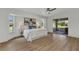 Tranquil main bedroom with wood floors, abundant natural light, and a slider to the lanai at 229 Waterside St, Port Charlotte, FL 33954