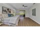 Bright main bedroom with wood floors, a view of the backyard, and stylish décor at 229 Waterside St, Port Charlotte, FL 33954