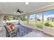 Cozy screened-in porch with seating, ceiling fan, and views of the outdoors, ideal for relaxing and entertaining at 229 Waterside St, Port Charlotte, FL 33954