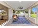 Relaxing screened-in porch with tiled floors, ceiling fan, and comfortable seating to enjoy indoor/outdoor living at 229 Waterside St, Port Charlotte, FL 33954