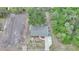 An aerial view showcases a home with a landscaped yard and a long driveway at 23165 Glen Ave, Punta Gorda, FL 33980