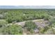 Aerial view featuring lush greenery surrounding the property and its surrounding landscape at 23165 Glen Ave, Punta Gorda, FL 33980