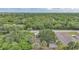 Aerial view showcasing the home's setting with lush greenery and privacy at 23165 Glen Ave, Punta Gorda, FL 33980