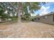 Spacious backyard featuring mature trees, offering ample space for outdoor activities and relaxation at 23165 Glen Ave, Punta Gorda, FL 33980