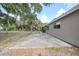 Expansive backyard showcasing a concrete patio, shed and mature trees at 23165 Glen Ave, Punta Gorda, FL 33980