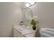 Well-lit bathroom with a vanity, mirror, and decorative accents, creating a cozy atmosphere at 23165 Glen Ave, Punta Gorda, FL 33980