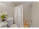 Clean bathroom featuring a toilet, bathtub with shower, and a vanity with decorative elements at 23165 Glen Ave, Punta Gorda, FL 33980