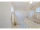 Cozy bathroom with a shower-tub combination, toilet, and vanity with sink and mirror at 23165 Glen Ave, Punta Gorda, FL 33980