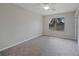 Bedroom features plush carpeting and a window providing natural light and a view of the surroundings at 23165 Glen Ave, Punta Gorda, FL 33980