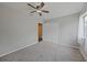 Bedroom featuring neutral walls, plush gray carpet, ceiling fan, and a double door closet at 23165 Glen Ave, Punta Gorda, FL 33980