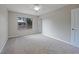 Bedroom with neutral carpet and a window overlooking the backyard, creating a peaceful retreat at 23165 Glen Ave, Punta Gorda, FL 33980