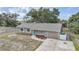 An elevated view showcases a single-story home with a well-manicured front yard and a driveway at 23165 Glen Ave, Punta Gorda, FL 33980