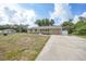 An angled shot showcases a single-story home with a driveway and a well-manicured front yard at 23165 Glen Ave, Punta Gorda, FL 33980