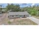 An aerial view highlights a single-story home with a driveway and a manicured front lawn at 23165 Glen Ave, Punta Gorda, FL 33980