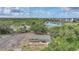 Exterior shot of a single-story home with a lake view and mature landscaping at 23165 Glen Ave, Punta Gorda, FL 33980
