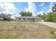 Charming single-story home with a well-maintained lawn and a paved driveway at 23165 Glen Ave, Punta Gorda, FL 33980