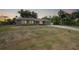 Charming single-story home featuring an attached garage, well-maintained front yard, and a welcoming blue front door at 23165 Glen Ave, Punta Gorda, FL 33980