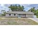 Charming single-story home with a front yard, neutral siding, and a pop of color on the front door at 23165 Glen Ave, Punta Gorda, FL 33980
