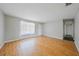 Spacious living room with wood floors and a view of the front door and hallway at 23165 Glen Ave, Punta Gorda, FL 33980