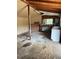 Inside the shed: unfinished walls, workbench, storage, and natural lighting at 23165 Glen Ave, Punta Gorda, FL 33980