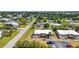 Aerial view of a home in a quiet neighborhood with lush greenery and a well-maintained lawn at 232 W Henry St, Punta Gorda, FL 33950
