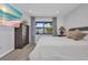 Well-lit bedroom with a bed, wardrobe, light wood flooring and a view to the outdoors at 232 W Henry St, Punta Gorda, FL 33950