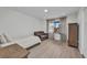 Well-lit bedroom with a loveseat, light wood flooring and a view to the outdoors at 232 W Henry St, Punta Gorda, FL 33950