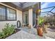 Welcoming front porch area with lovely foliage, comfortable seating, and a clear view to the entry door at 232 W Henry St, Punta Gorda, FL 33950