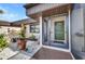 Charming entrance featuring an inviting doorway, decorative planters, and a peaceful sitting area at 232 W Henry St, Punta Gorda, FL 33950