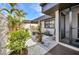 Charming front patio area featuring lush greenery, a view of the door, and a welcoming ambiance at 232 W Henry St, Punta Gorda, FL 33950