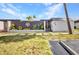 Front exterior of a home featuring decorative fencing, lush landscaping, and well-manicured grass at 232 W Henry St, Punta Gorda, FL 33950