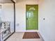 Welcoming front door area featuring a colorful door and a cozy spot to relax on the porch at 232 W Henry St, Punta Gorda, FL 33950