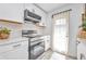 Well-equipped kitchen with stainless steel appliances and white cabinetry, offering modern convenience at 232 W Henry St, Punta Gorda, FL 33950