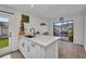 Bright kitchen featuring white cabinetry, modern countertops, and a view to a charming outdoor patio at 232 W Henry St, Punta Gorda, FL 33950