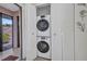 Convenient laundry closet features stacked washer and dryer, maximizing space in a functional and well-organized setup at 232 W Henry St, Punta Gorda, FL 33950