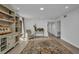 Bright living room featuring a comfortable chair, stylish rug, and custom built in shelving at 232 W Henry St, Punta Gorda, FL 33950