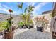 Relaxing outdoor patio featuring beautiful greenery, a stone wall, and a serene atmosphere at 232 W Henry St, Punta Gorda, FL 33950