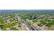 Aerial view of property in lush neighborhood with canal access, a boat dock, and screened-in pool at 2399 Bendway Dr, Port Charlotte, FL 33948