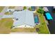 Home featuring a private screened-in pool, a boat dock, and a well-maintained lawn at 2399 Bendway Dr, Port Charlotte, FL 33948