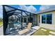 Relaxing backyard oasis featuring a screened pool, comfortable lounge chairs, and well-manicured landscaping at 2399 Bendway Dr, Port Charlotte, FL 33948