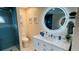 Bathroom featuring a modern vanity, a circular mirror, and glass-enclosed shower with rain shower head at 2399 Bendway Dr, Port Charlotte, FL 33948