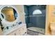 Bathroom with a modern vanity, LED mirror, and glass-enclosed shower with built-in seat at 2399 Bendway Dr, Port Charlotte, FL 33948