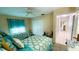 Bedroom features two beds with matching comforters, a ceiling fan, and a double closet at 2399 Bendway Dr, Port Charlotte, FL 33948