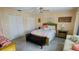 Bright bedroom features double closets and a cozy seating area by the window at 2399 Bendway Dr, Port Charlotte, FL 33948