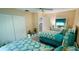 Bright bedroom featuring two beds with white frames, teal accents, and a double closet at 2399 Bendway Dr, Port Charlotte, FL 33948