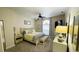 Bright bedroom features neutral walls, ceiling fan, carpet flooring and a queen bed at 2399 Bendway Dr, Port Charlotte, FL 33948