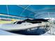 Close-up shot of white and blue boat underneath covered top at 2399 Bendway Dr, Port Charlotte, FL 33948