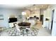 Open-concept dining and kitchen with natural light, modern décor, and tile flooring at 2399 Bendway Dr, Port Charlotte, FL 33948