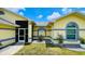 Landscaped home exterior with plants, grey rock accents and a cozy front door at 2399 Bendway Dr, Port Charlotte, FL 33948