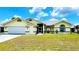 Charming one-story home featuring a well-maintained lawn and attached two-car garage at 2399 Bendway Dr, Port Charlotte, FL 33948